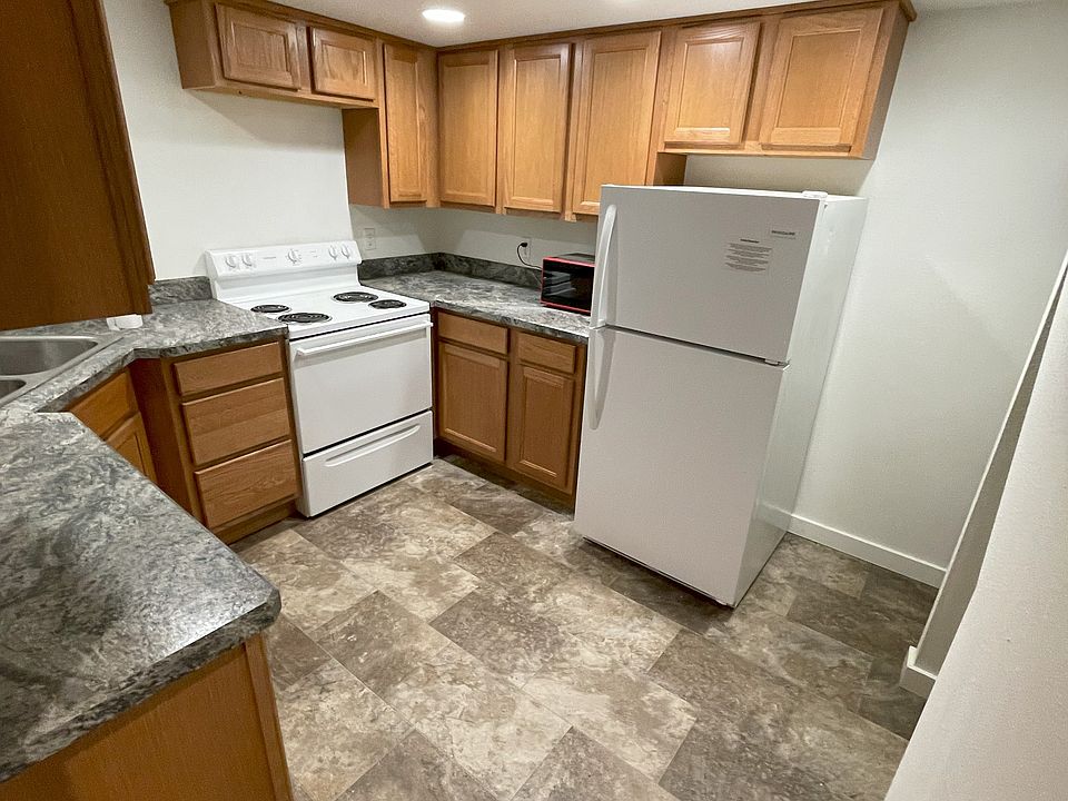 Kitchen with sink, stove, oven, fridge, freezer, microwave.