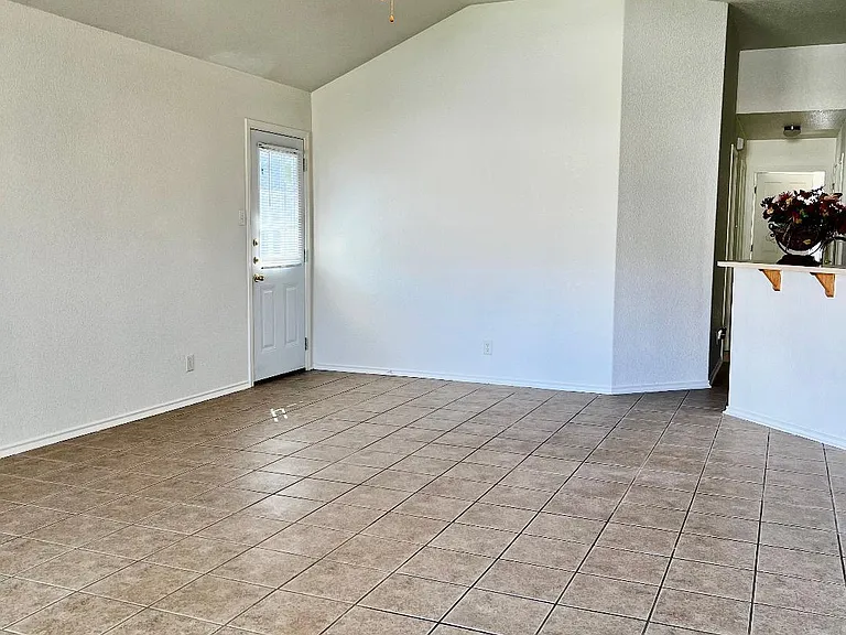 VIEW OF LIVING ROOM, BACK DOOR AND KITCHEN ENTRANCE
