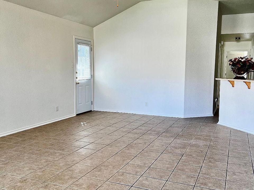 VIEW OF LIVING ROOM, BACK DOOR AND KITCHEN ENTRANCE