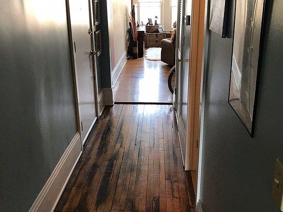 Hallway from Kitchen to Living Room.  Entry door on left.  B