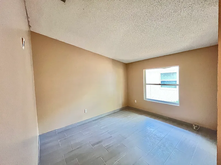 3rd bedroom with large window vaulted ceiling