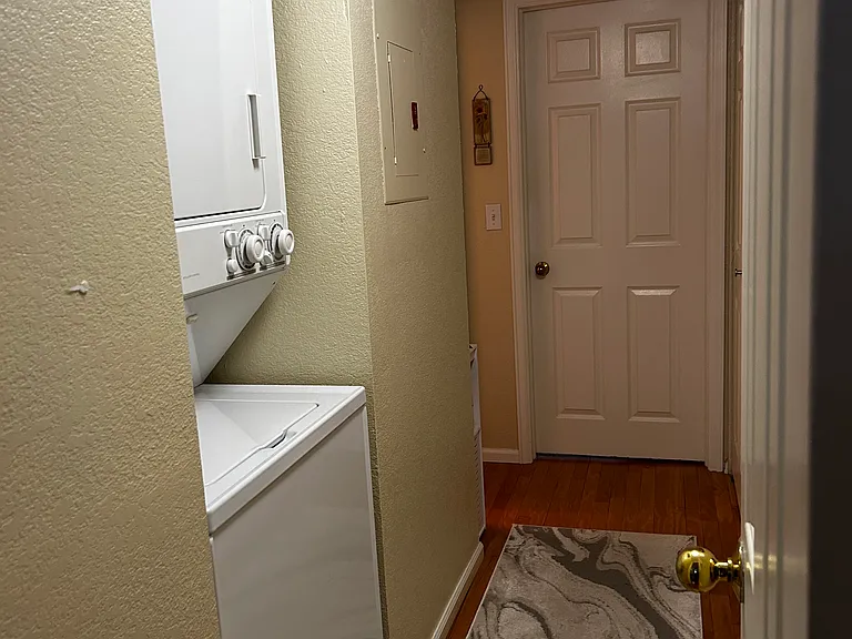 hallway with washer/dryer unit and pantry