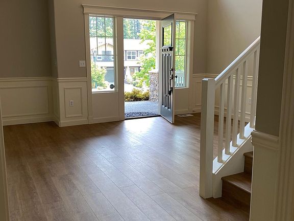 grand entry with high ceiling, new flooring, new paint