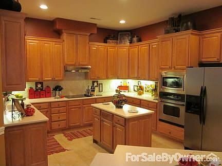 Kitchen
						:
						Corian countertops, large island, SS appliances, and tumbled tile backsplash