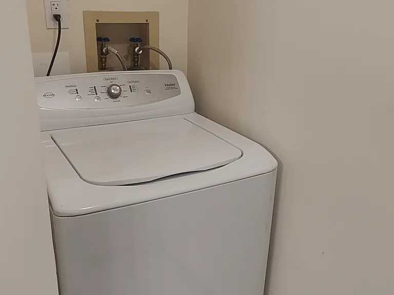 Laundry attached to kids bathroom. Washing machine