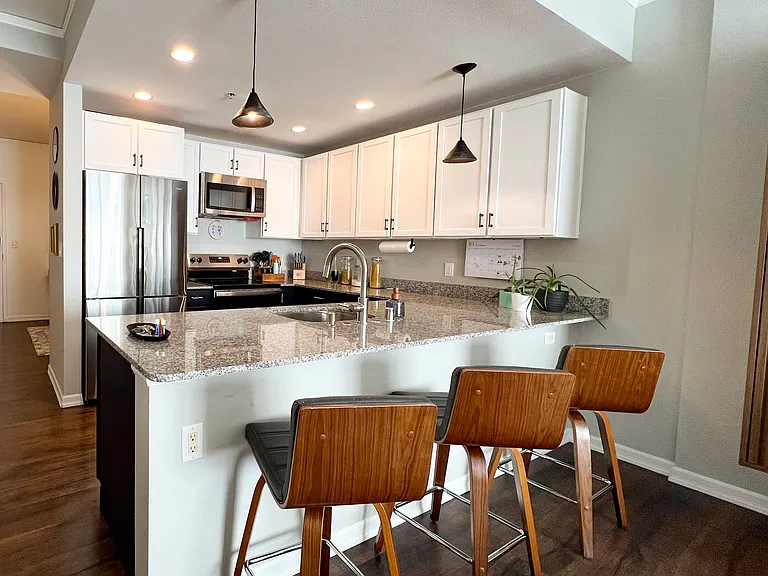 Full kitchen furnished with Calphalon cookware, granite countertops, stainless steel appliances including a dishwasher.
