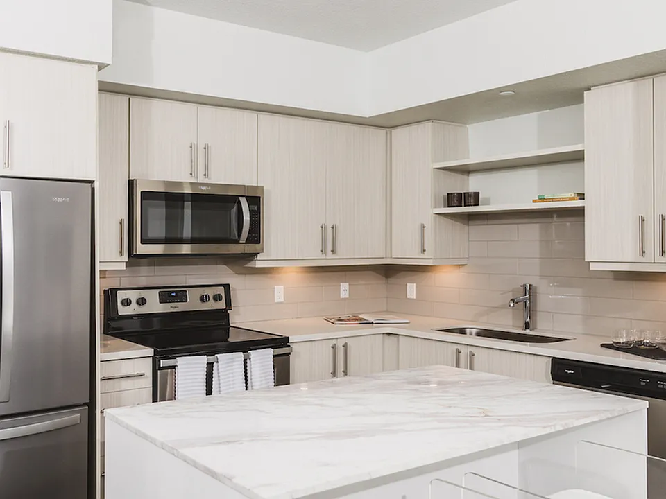 Stunning kitchens with french door stainless steel refrigerators, quartz counters, tile backsplash, and built in shelving