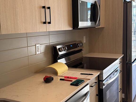 Kitchen counter, dishwasher, cainets, microwave, fridge