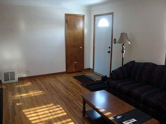 Living room with view to the front door and coat closet.