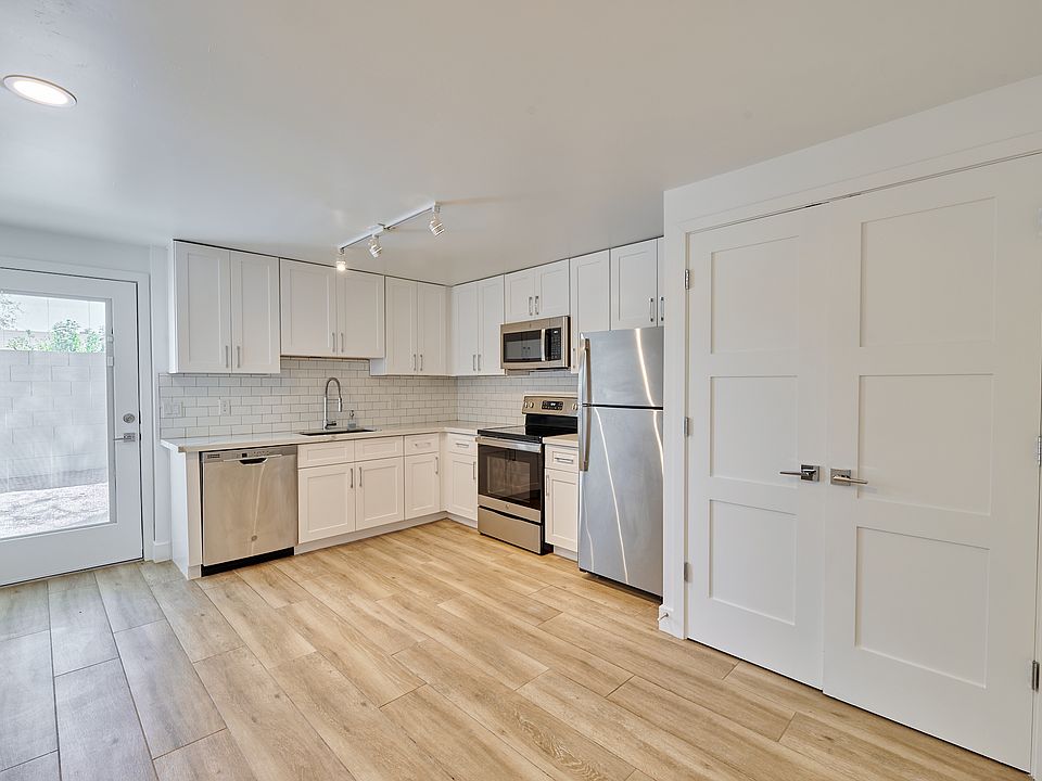 Kitchen with updated appliances and door to backyard