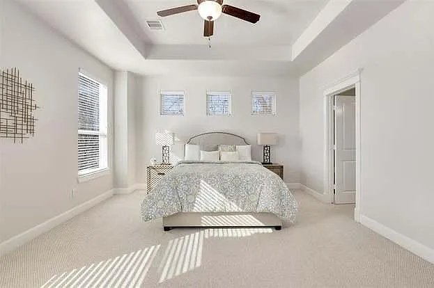 Digital furnaced to show beautiful primary bedroom space with natural light.