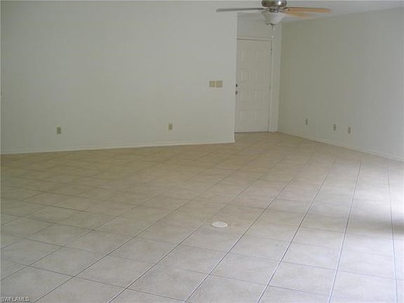 The living area is wide open, features tile floor and vaulted ceilings.