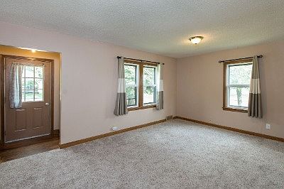Living room with new carpet and newer windows.