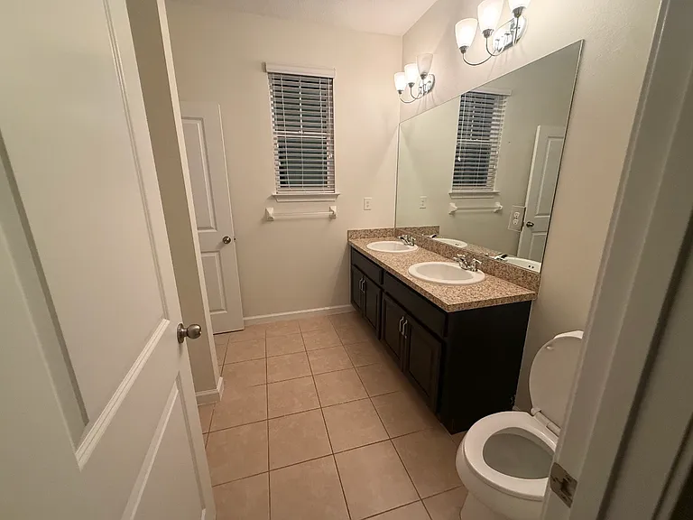 Secondary bathroom with granite countertop.
