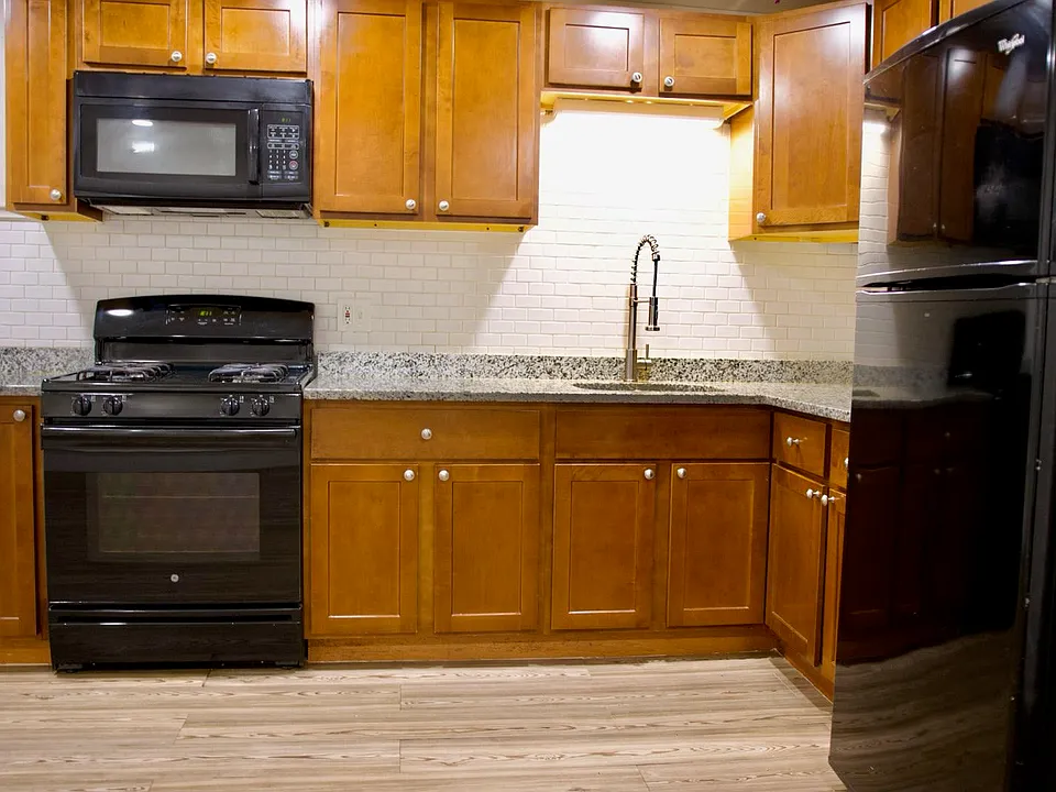 kitchen area newly tiled - new countertops, range stove, microwave and fridge