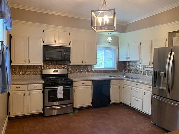 The updated, fully equipped kitchen features stainless steel appliances and new lighting.