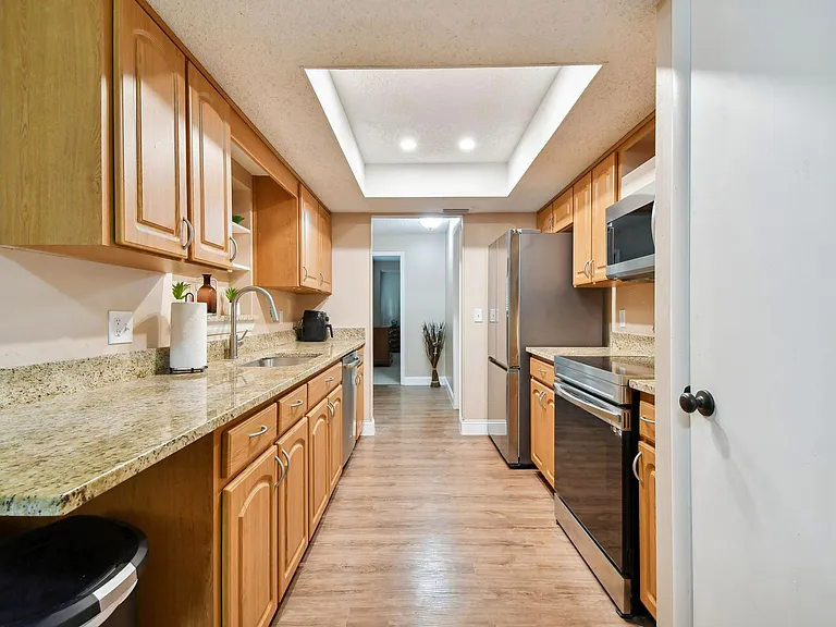 Updated kitchen with granite counter tops and stainless steel appliances