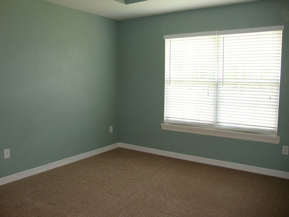 Master Bedroom with try ceiling and two walk in closets