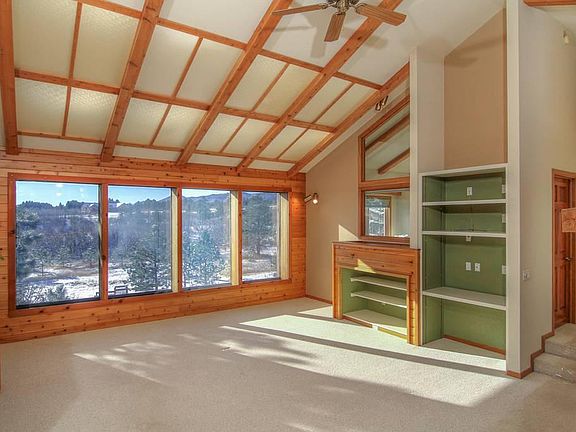 Upstairs living room with built ins and skylights