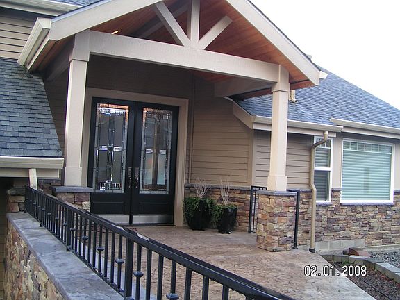 Stone accents, stamped concrete, gorgeous doors