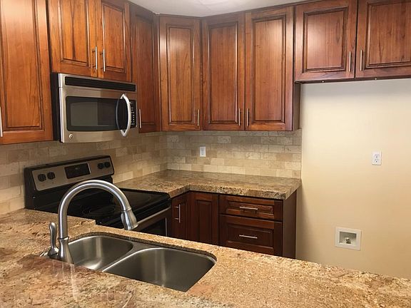 Granite Counters with Travertine Back Splash.
