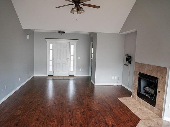 Open living area with gas fireplace and removable TV mount (