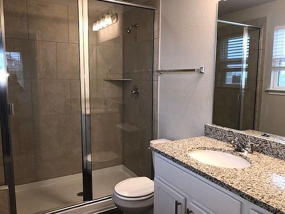Walk-in shower and granite countertops.