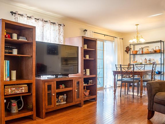 View across living room to dining area and patio entrance.