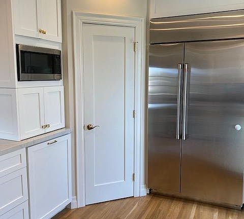 Microwave, appliance garage below, pull out trash and large pantry.