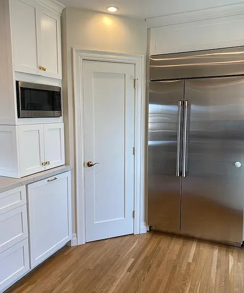 Microwave, appliance garage below, pull out trash and large pantry.