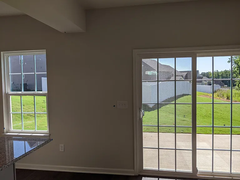 A view from kitchen into a backyard