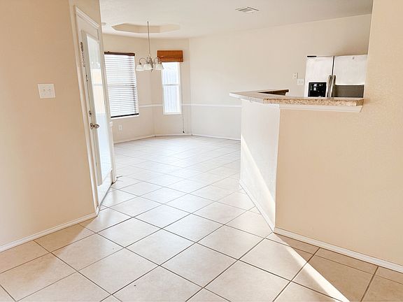 From the living room toward the dinette, kitchen, & backdoor left side.