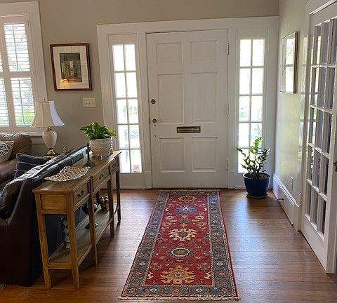 Large sunny living room with beautiful hardwoods. Wood plantation blinds are in most rooms on first and second floor