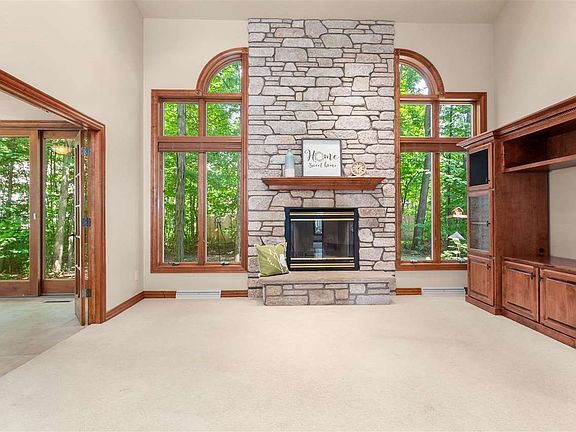 Great Rm has dramatic wall of windows & stone Fireplace