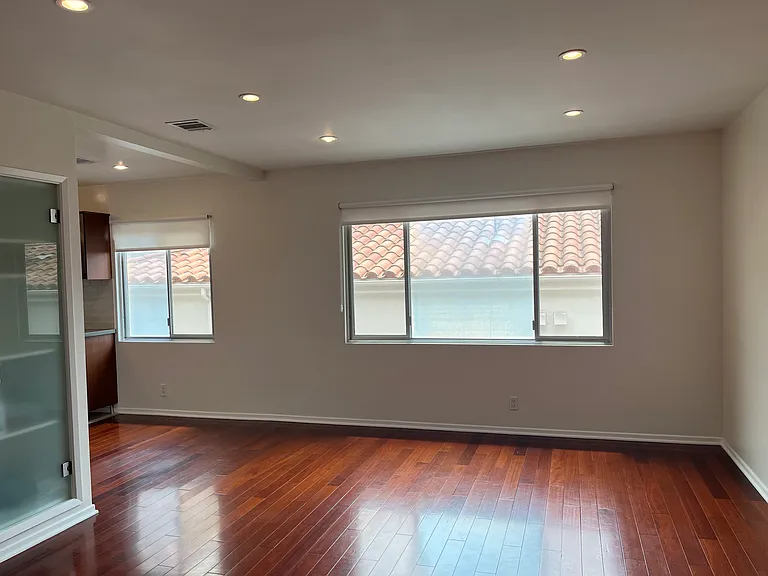 Living room, hardwood floor and lots of windows