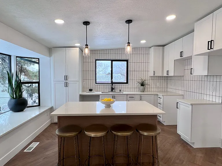 Shared kitchen equipped with frige, sink, oven, stovetop and dishwasher.