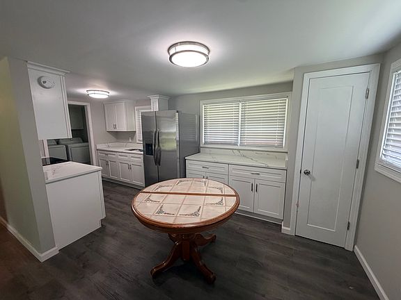 new galley kitchen with new cabinets, marble countertops and pantry.