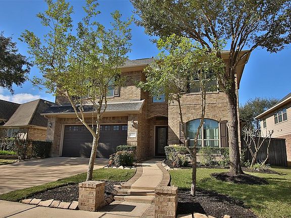Pretty winding walkway to the covered porch of this David Powers home.