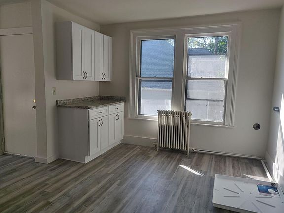 Open kitchen with lots of natural light. Radiators give charm to the overall look while being high efficiency thanks to brand new high efficiency gas furnace.