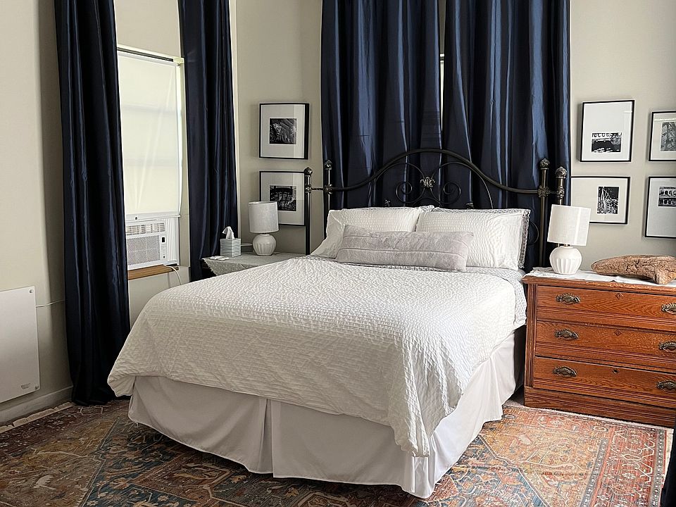 ample natural light and layered blinds and blackout curtains for privacy