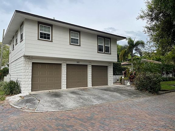 garage bays are 10x28 deep. Two bays convey with the home