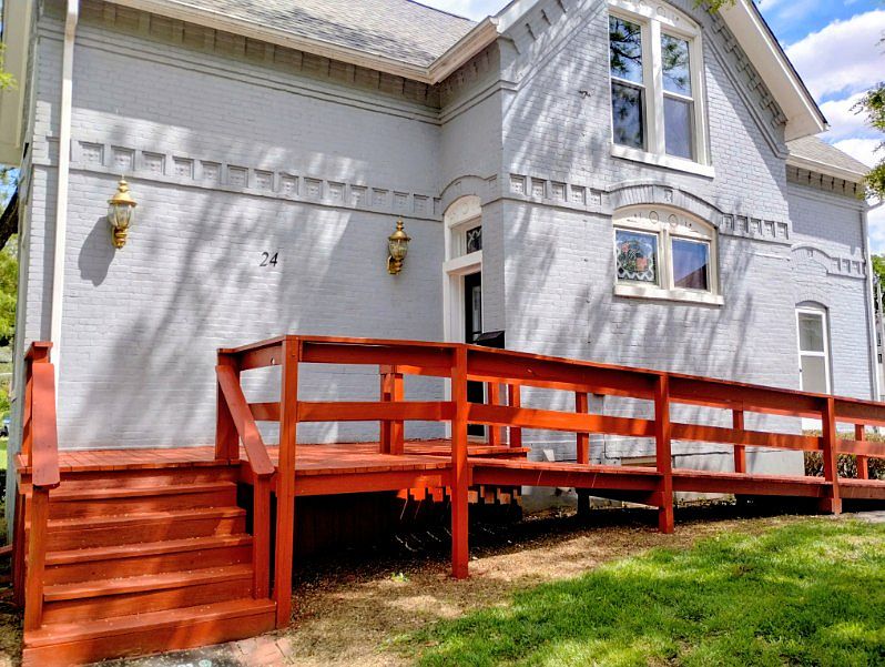 ENTRANCETO THE HOUSE. WITH NEWLY PAINTED PORCH, STEPS AND RAMP.