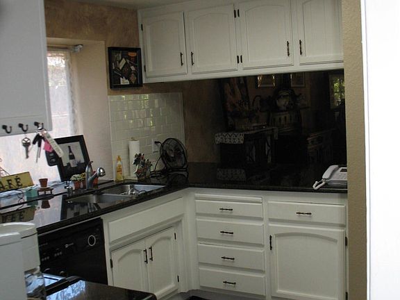 White cabinetry provides a crisp look with the dark granite counters.