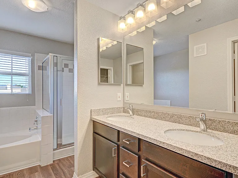 Quartz or Granite counters and custom cabinetry continue into the bathroom