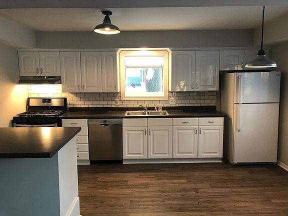 Kitchen with new appliances, including Bosch dishwasher.