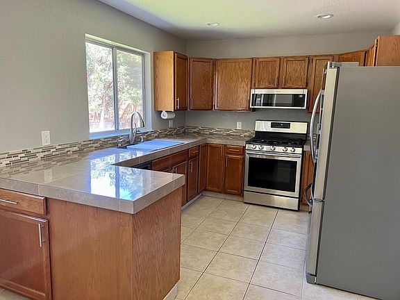 Newly remodeled kitchen with great views. Includes refrigerator, dishwasher, range, microwave.
