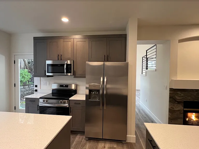 Kitchen, downstairs fireplace in family room