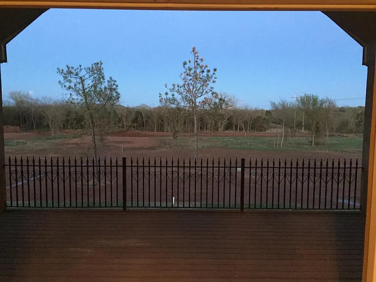 View of green belt from the great room with balcony doors open.