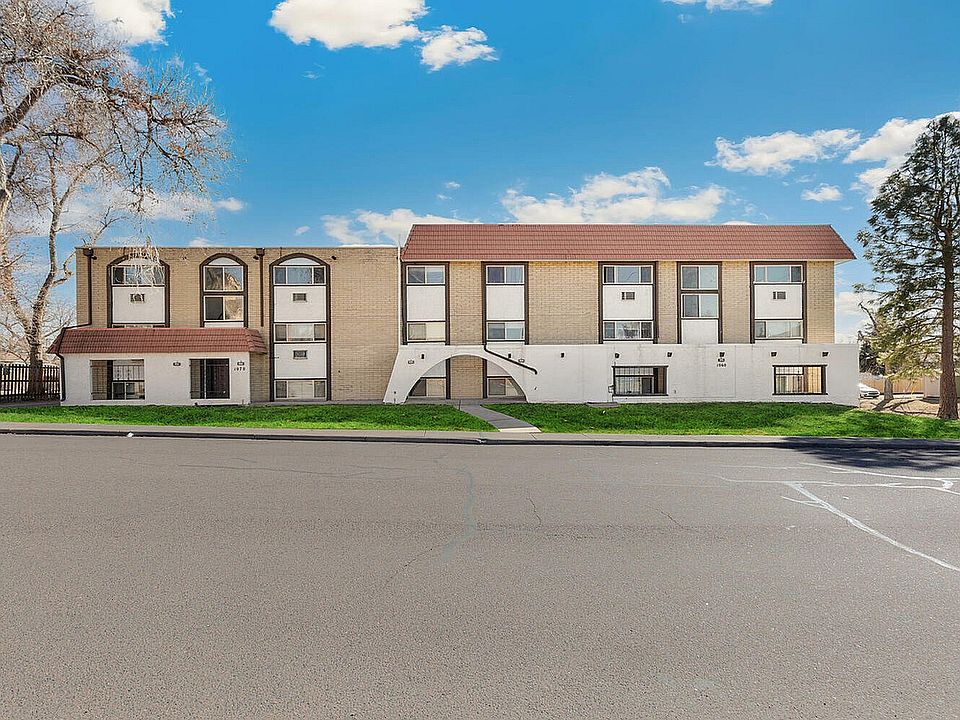 Charming apartment building with modern architecture, featuring large windows and scenic views.
