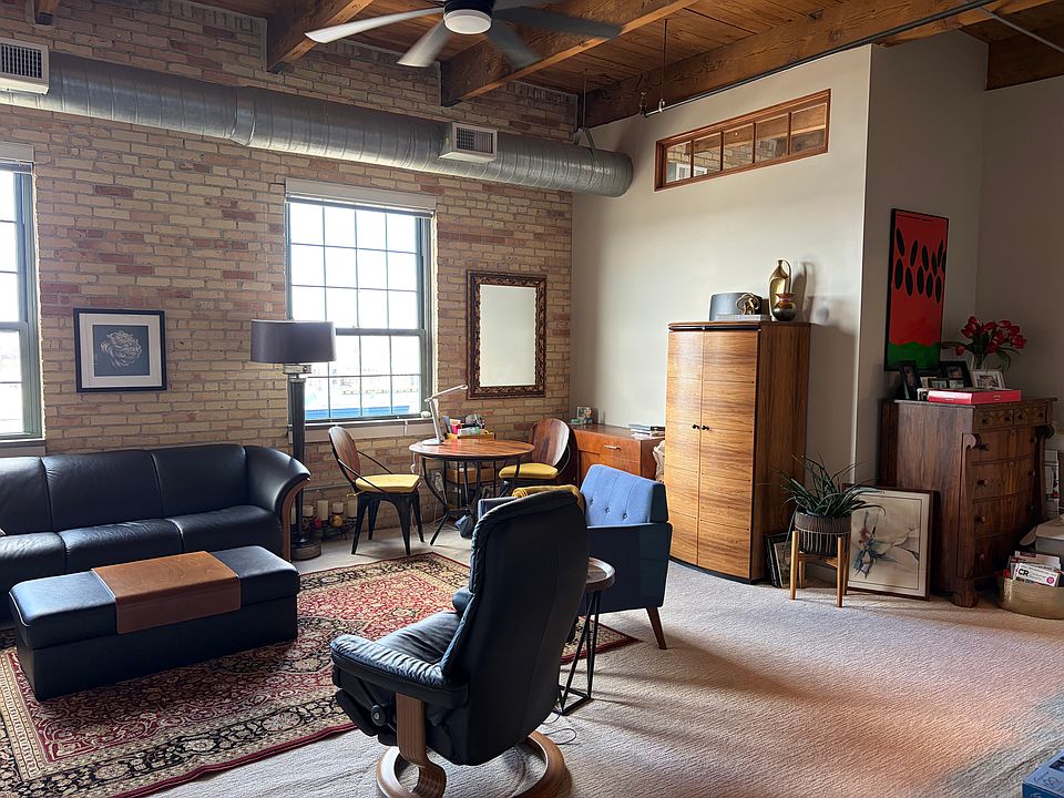 Large living room with brick wall